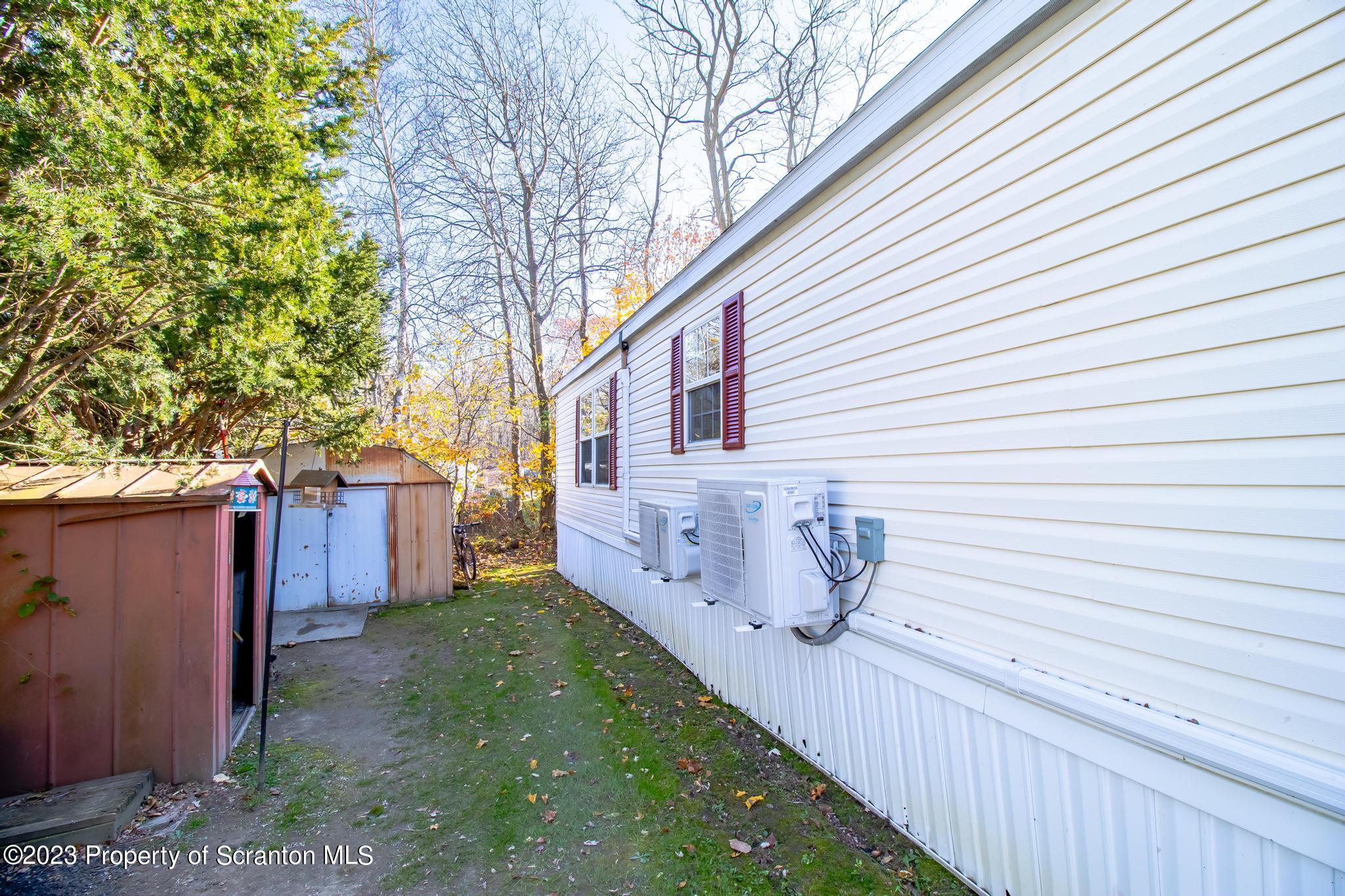 45 Honor Park Moosic, PA 18507 - Photo 11 of 16 a view of a house with a small yard and a large tree
