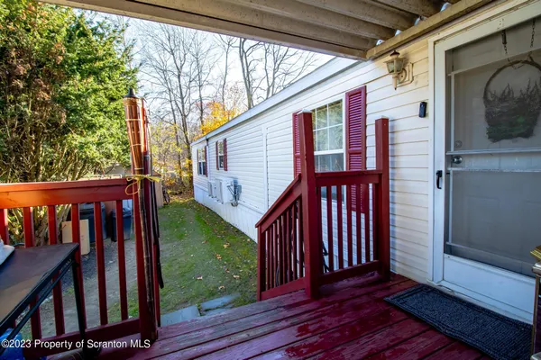 a view of a house with backyard and deck