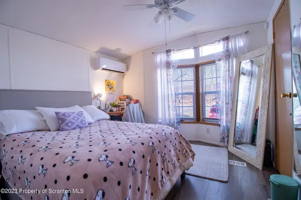 a bedroom with a large bed and a chandelier