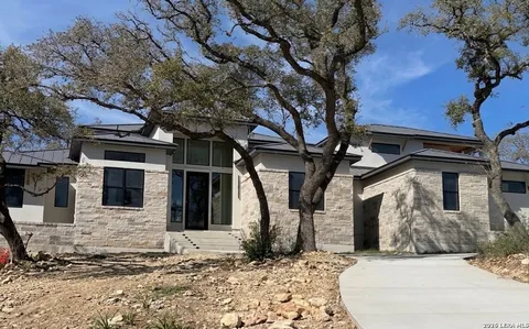 a view of a house with a large tree