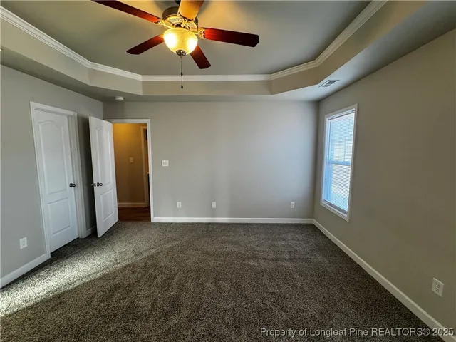 en empty room with windows and fan