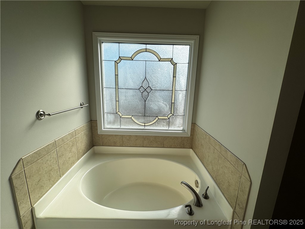 1328 St Johns Loop Raeford, NC 28376 - Photo 16 of 27 a bathroom with a tub