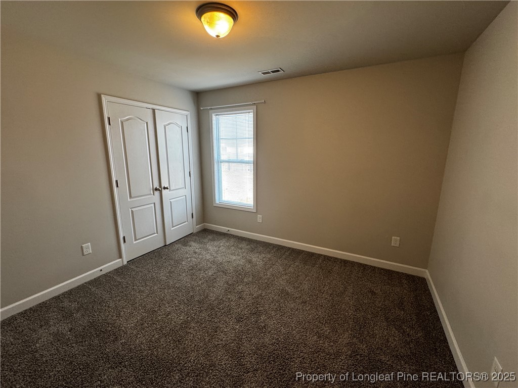 1328 St Johns Loop Raeford, NC 28376 - Photo 18 of 27 an empty room with windows