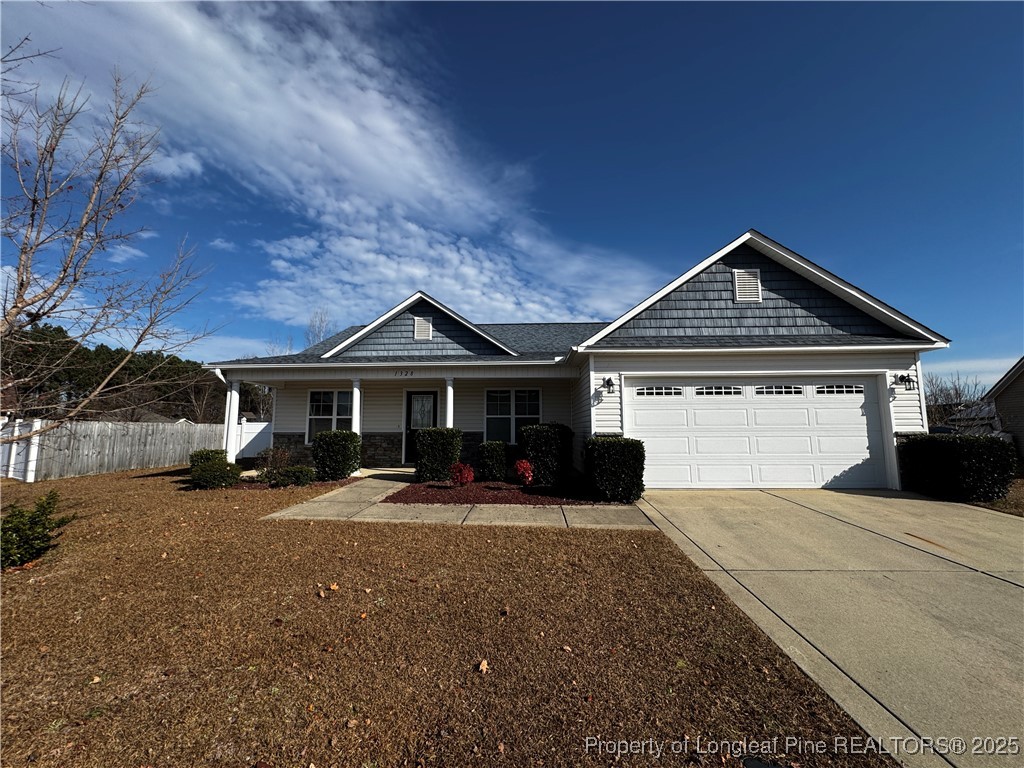 1328 St Johns Loop Raeford, NC 28376 - Photo 2 of 27 a front view of a house with a yard