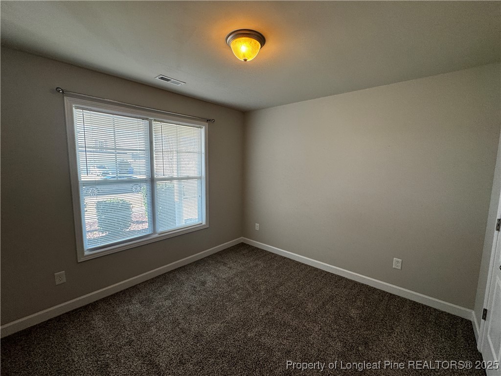 1328 St Johns Loop Raeford, NC 28376 - Photo 21 of 27 an empty room with windows