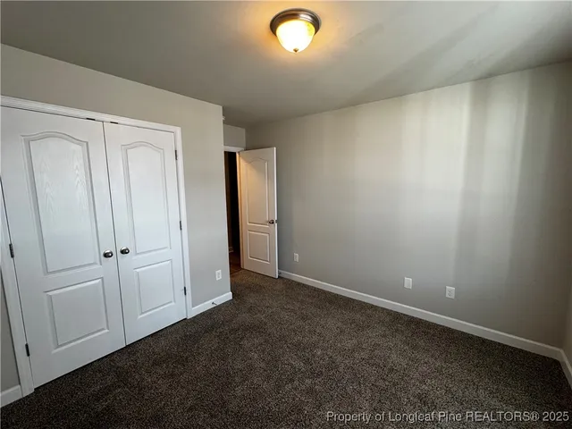 an empty room with closet area