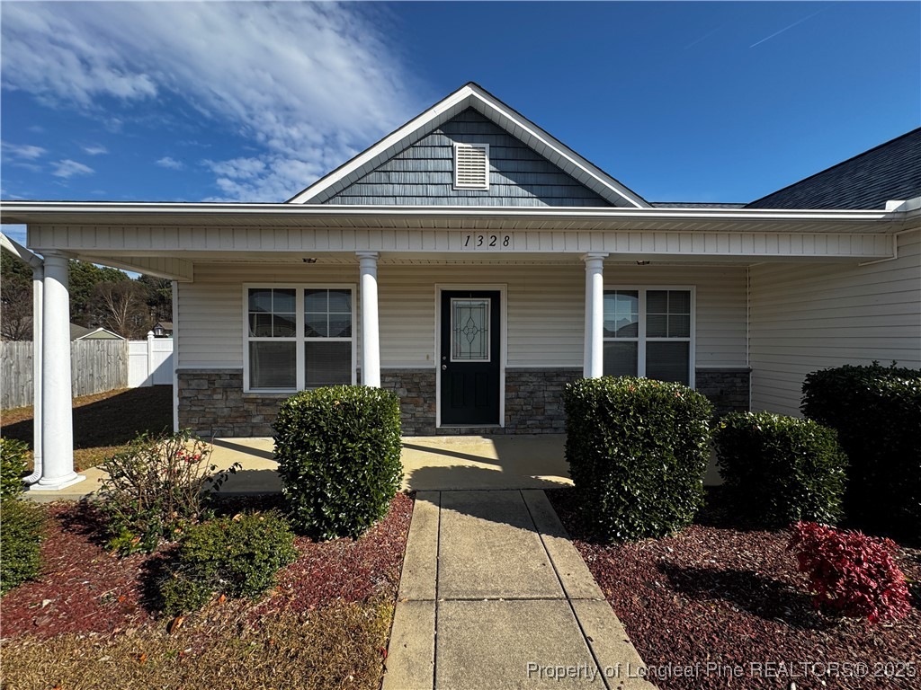 1328 St Johns Loop Raeford, NC 28376 - Photo 4 of 27 a front view of a house with garden