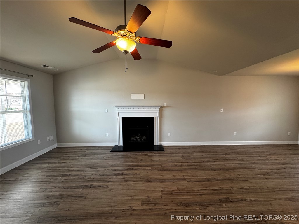 1328 St Johns Loop Raeford, NC 28376 - Photo 7 of 27 an empty room with wooden floor fan and windows