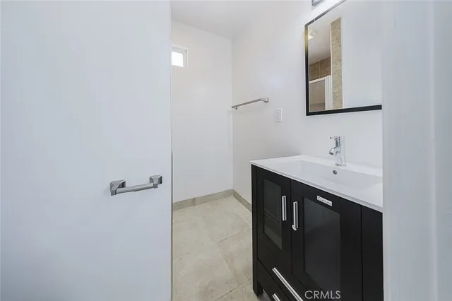a bathroom with a sink a mirror and shower