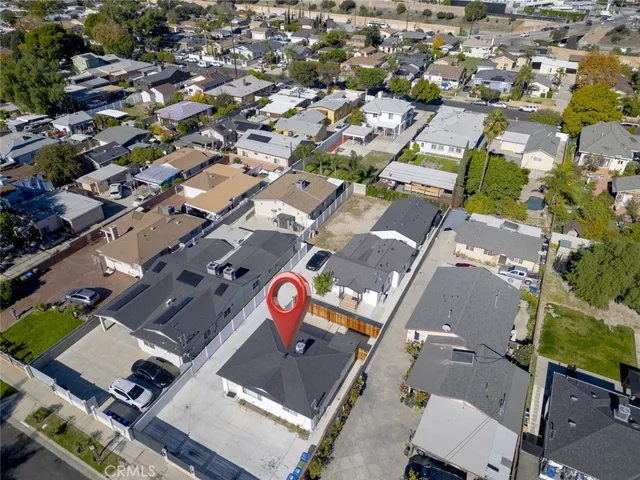 an aerial view of a city with lots of residential buildings and mountain view in back