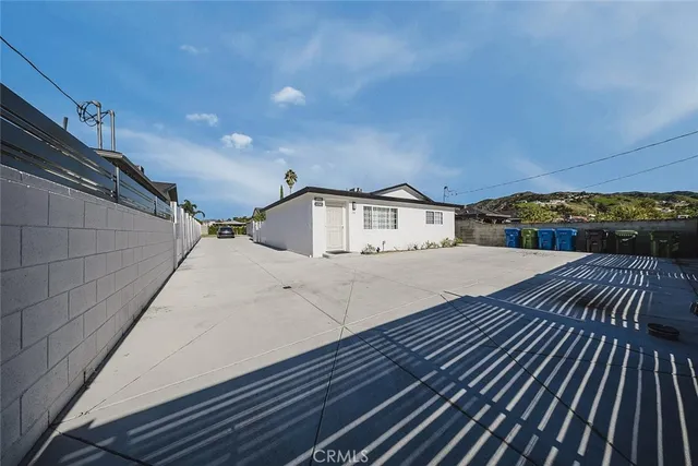a view of a house with a wooden fence