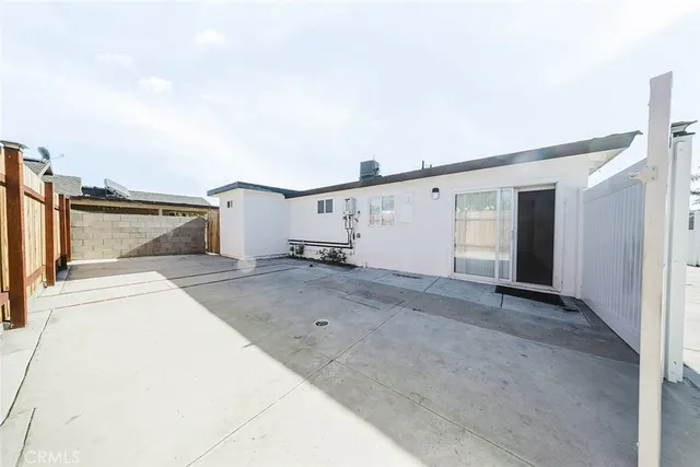 a kitchen with stainless steel appliances kitchen island granite countertop a refrigerator and a sink