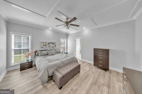 a bedroom with a large bed and a window