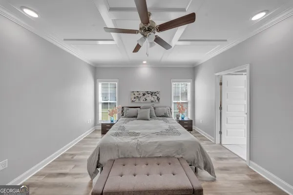 a bedroom with a large bed and a chandelier