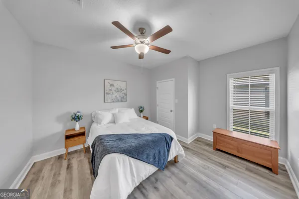 a bedroom with a bed and a window