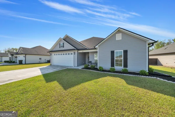 a front view of a house with a yard