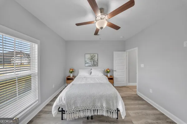a bedroom with a large bed and a chandelier