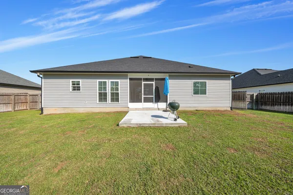 a view of a house with a backyard