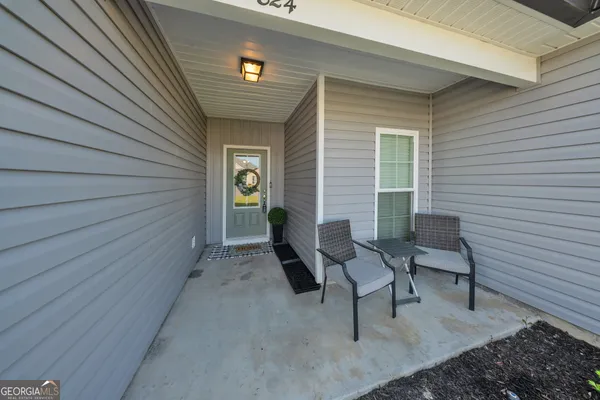 a view of a patio with chairs and a table