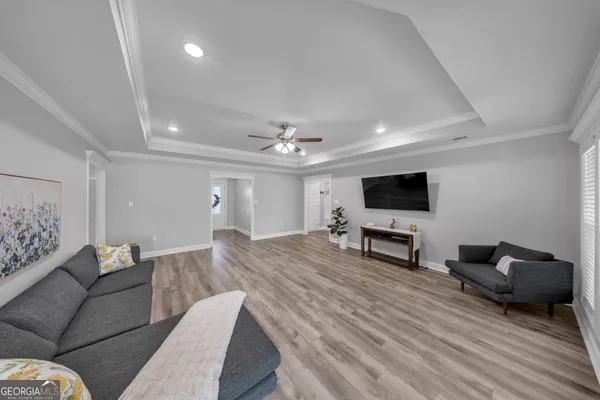 a living room with furniture and a flat screen tv