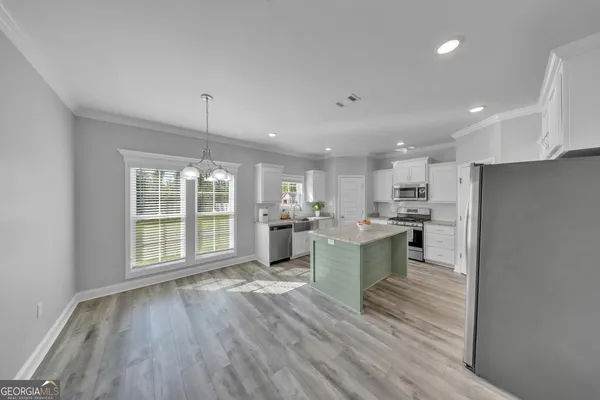 a large kitchen with a lot of counter space and stainless steel appliances