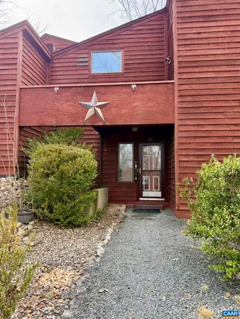 a view of a brick house with potted plants