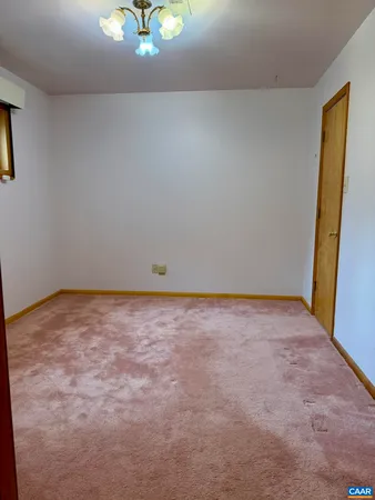a spacious bathroom with a granite countertop sink a toilet and a mirror