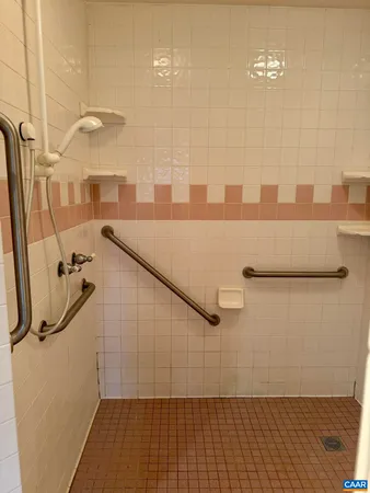 a spacious bathroom with a double vanity sink and a mirror