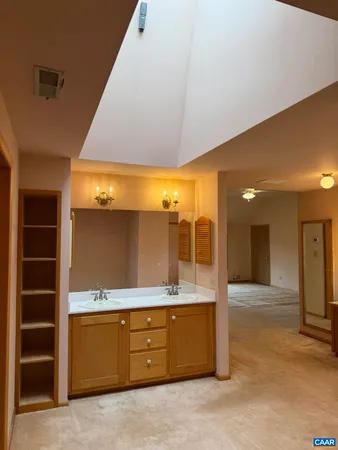 a view of an empty room with a kitchen