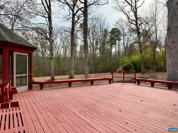 a backyard of a house with barbeque oven table and chairs