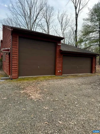 a view of a room with a wooden floor and a fireplace