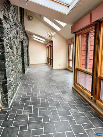a view of an empty room with a fireplace and a window