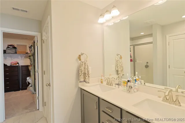 a bathroom with a sink double vanity and a mirror