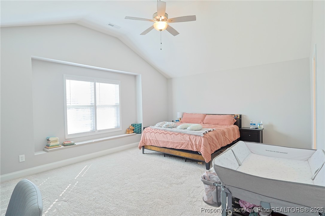 7810 Rufus Johnson Road St. Pauls, NC 28384 - Photo 12 of 24 a spacious bedroom with a bed and a chandelier