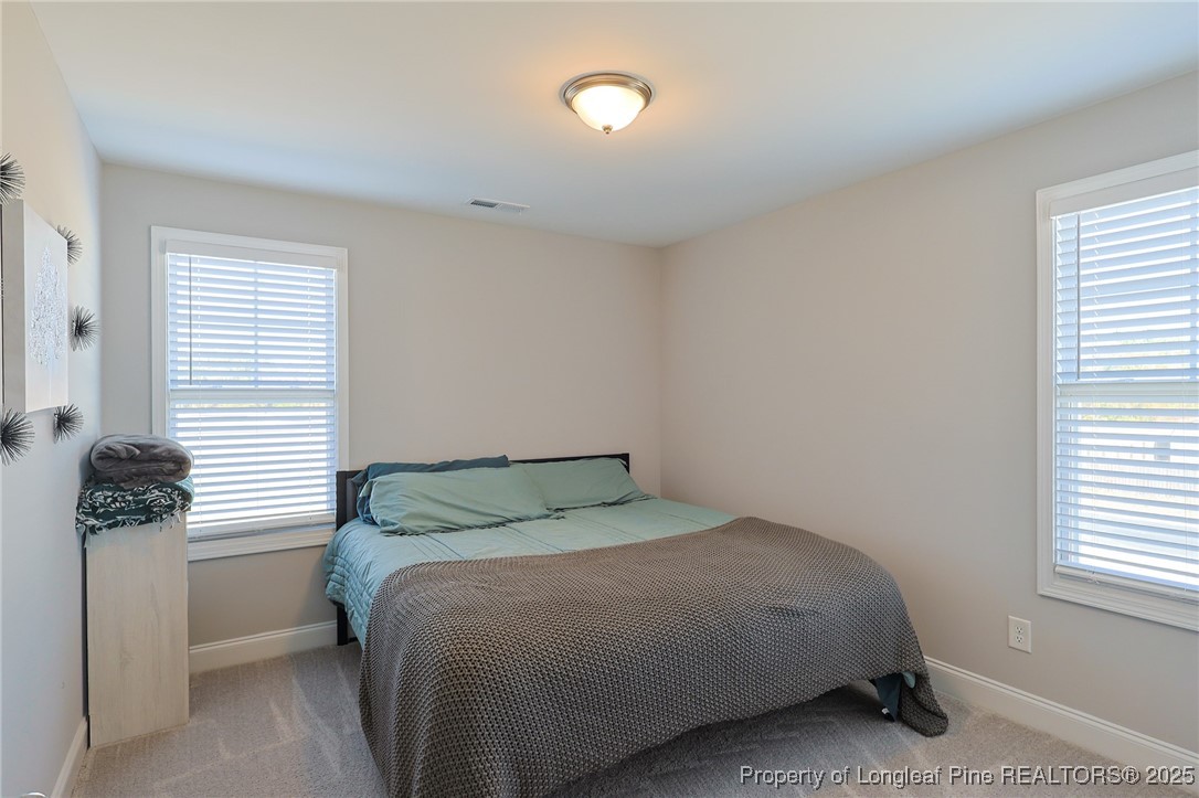 7810 Rufus Johnson Road St. Pauls, NC 28384 - Photo 15 of 24 a bedroom with a bed and window