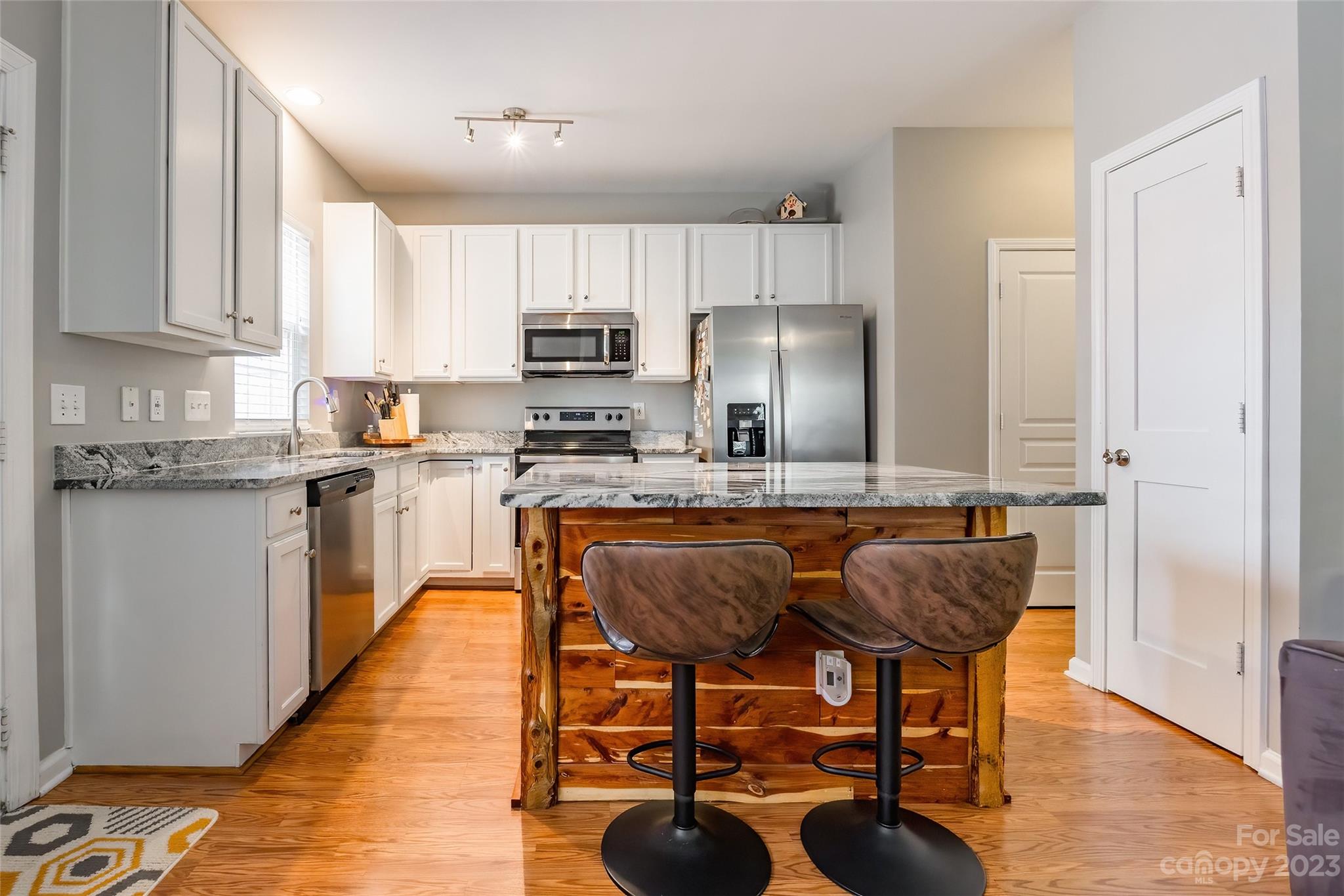 3114 Tanzanite Circle Fort Mill, SC 29708 - Photo 11 of 31 a kitchen with stainless steel appliances granite countertop a sink a stove a refrigerator cabinets and chairs