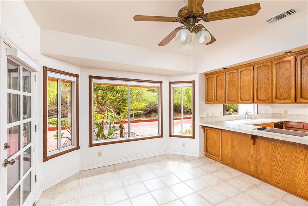 1766 Rabbit Hill Fallbrook, CA 92028 - Photo 22 of 75 a kitchen with stainless steel appliances granite countertop a sink and a window