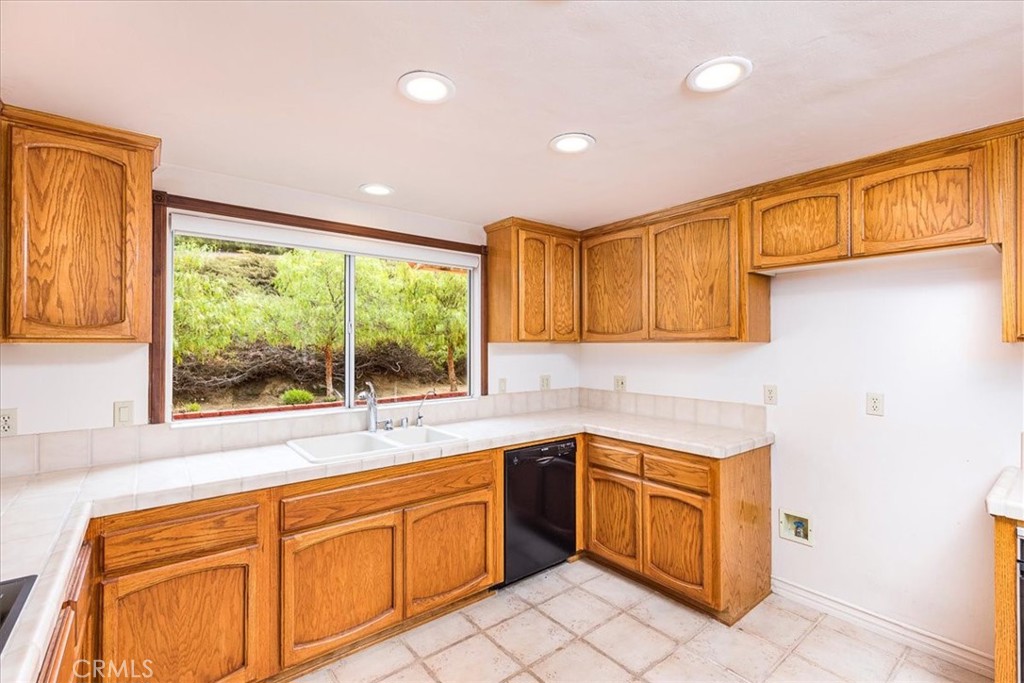 1766 Rabbit Hill Fallbrook, CA 92028 - Photo 24 of 75 a kitchen that has a sink and a stove top oven
