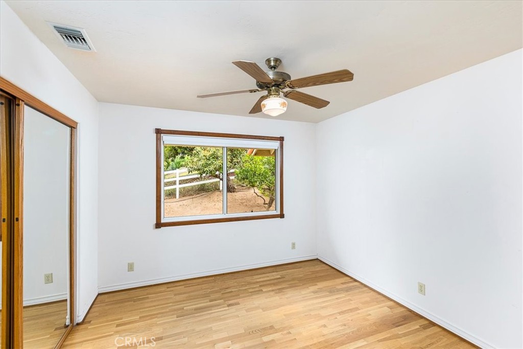 1766 Rabbit Hill Fallbrook, CA 92028 - Photo 35 of 75 an empty room with a window and a ceiling fan