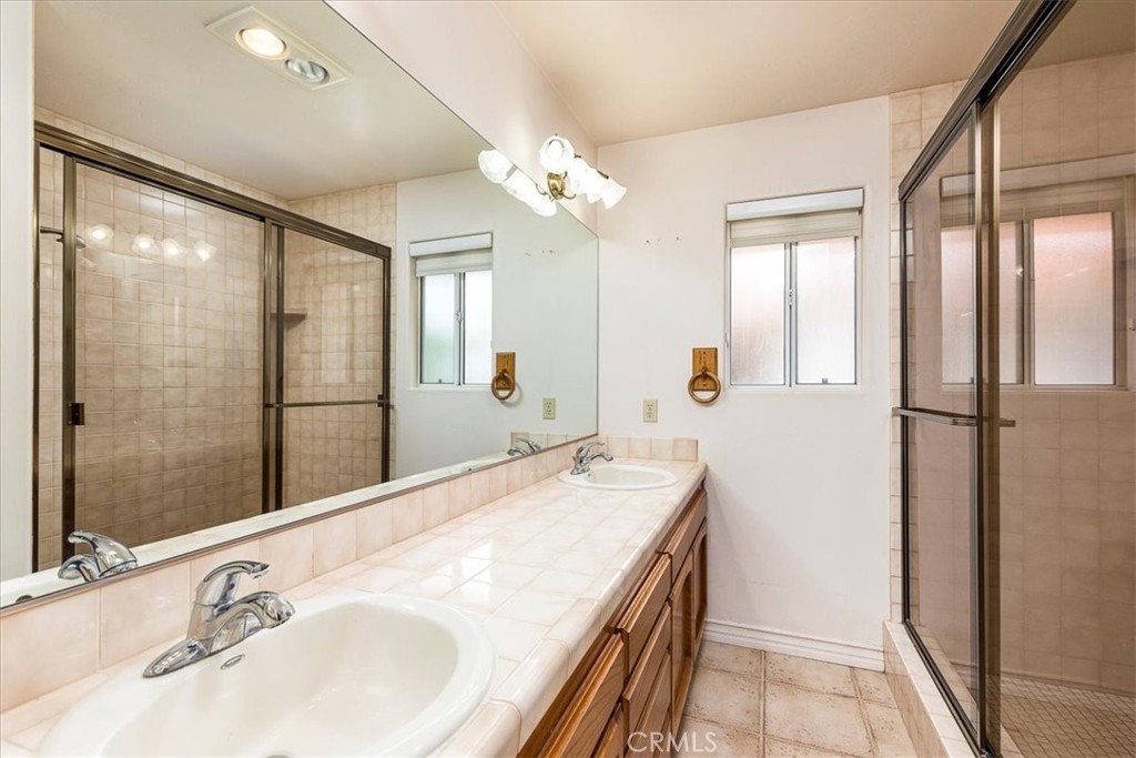 1766 Rabbit Hill Fallbrook, CA 92028 - Photo 39 of 75 a bathroom with a double vanity sink and a mirror