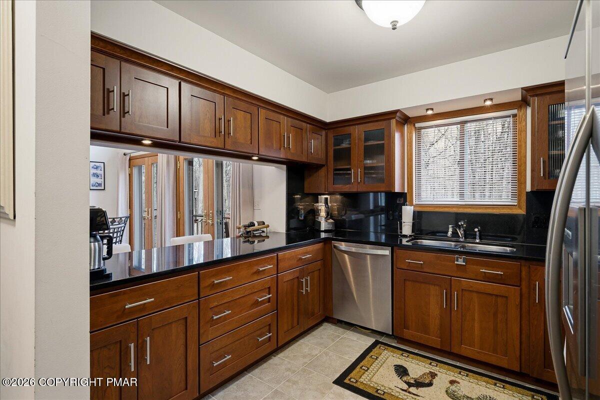 3176 Bluebird Drive Bushkill, PA 18324 - Photo 11 of 37 a kitchen with stainless steel appliances granite countertop a refrigerator and wooden cabinets
