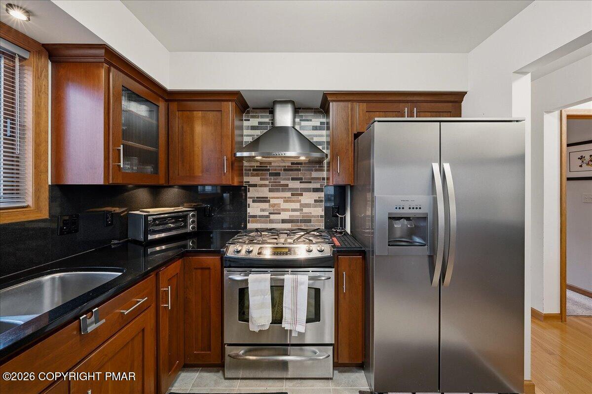 3176 Bluebird Drive Bushkill, PA 18324 - Photo 13 of 37 a kitchen with granite countertop a refrigerator and a sink
