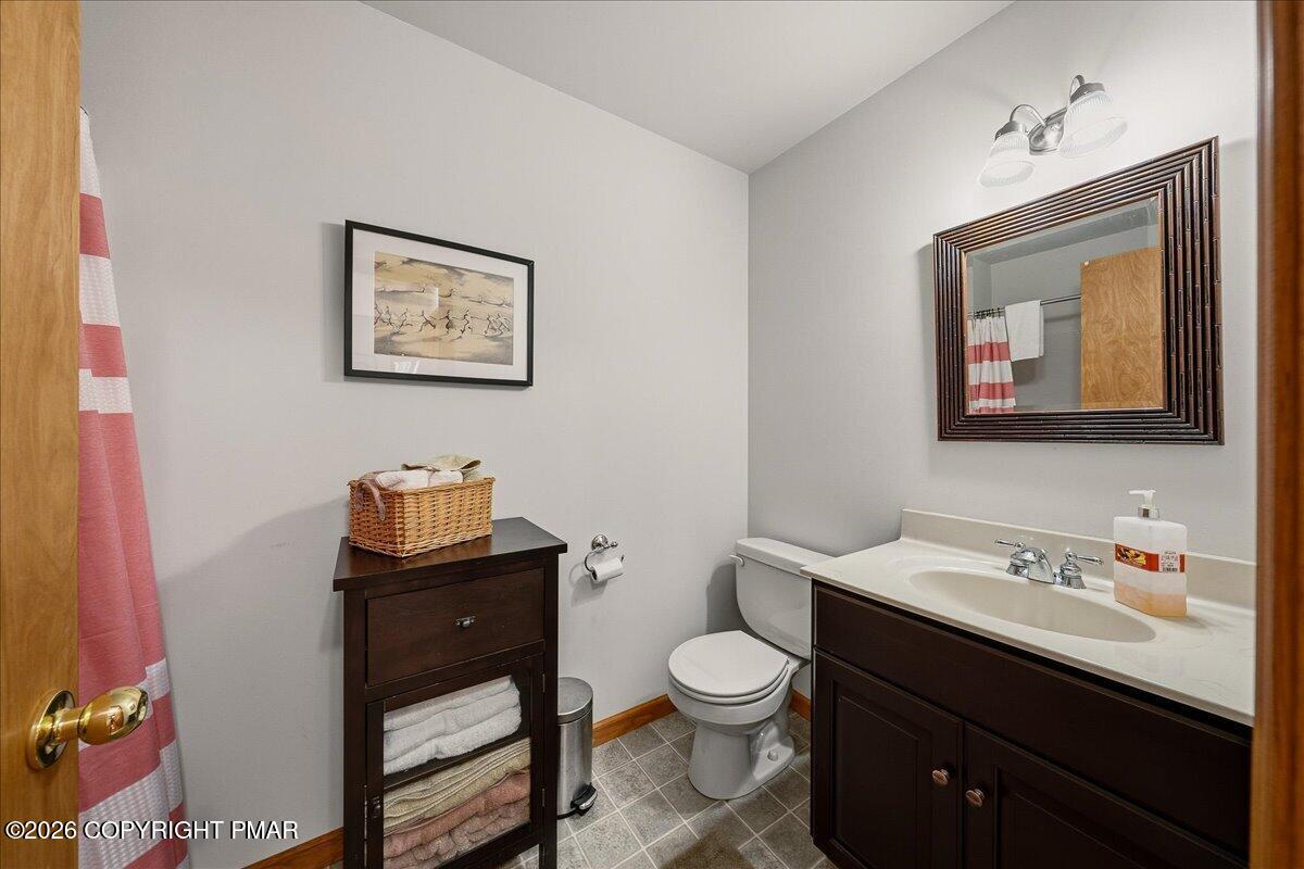 3176 Bluebird Drive Bushkill, PA 18324 - Photo 17 of 37 a bathroom with a toilet sink and mirror