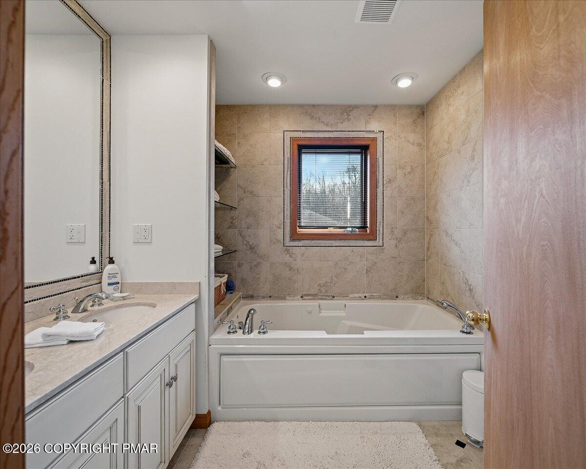 3176 Bluebird Drive Bushkill, PA 18324 - Photo 23 of 37 a bathroom with a bathtub and a sink
