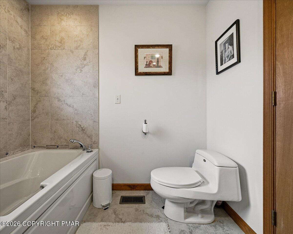 3176 Bluebird Drive Bushkill, PA 18324 - Photo 25 of 37 a bathroom with a toilet and a bathtub
