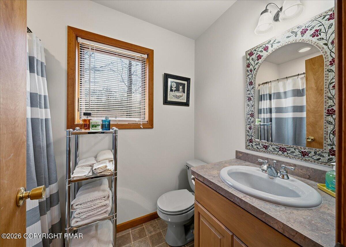3176 Bluebird Drive Bushkill, PA 18324 - Photo 28 of 37 a bathroom with a granite countertop toilet and a sink