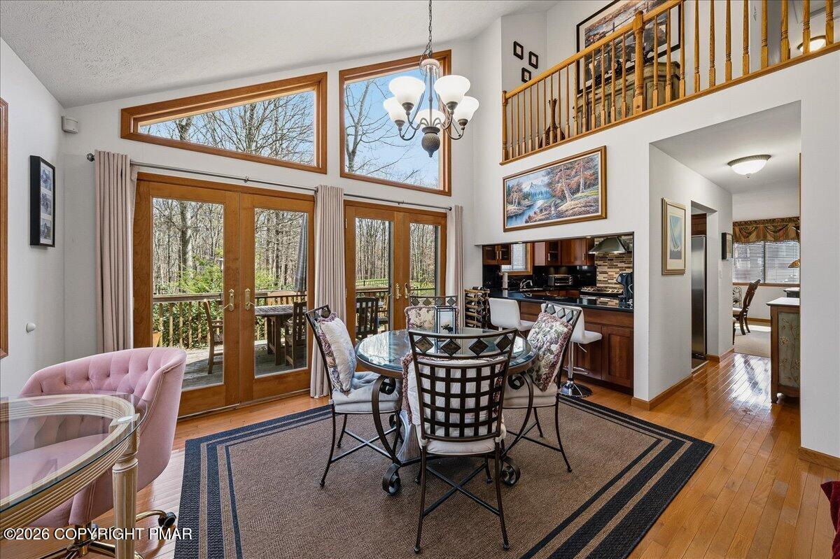 3176 Bluebird Drive Bushkill, PA 18324 - Photo 3 of 37 a dining room with furniture large windows and wooden floor