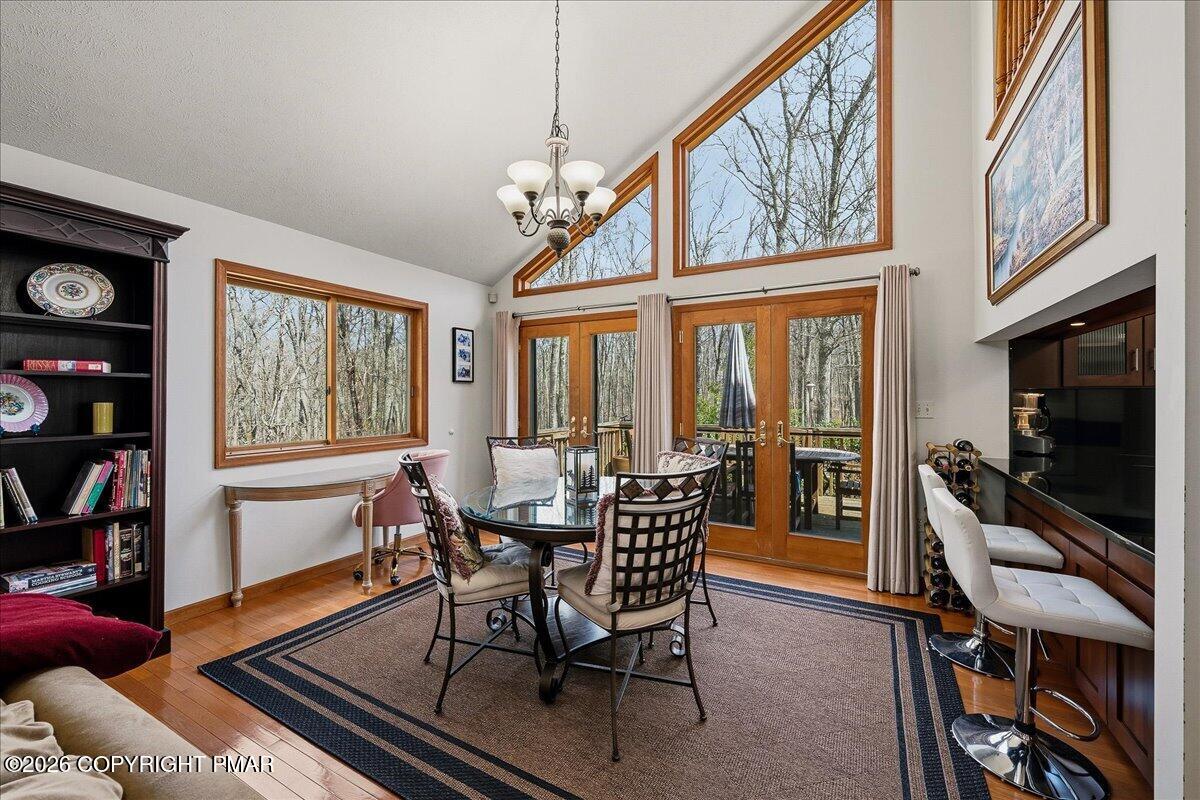 3176 Bluebird Drive Bushkill, PA 18324 - Photo 4 of 37 a dining room with furniture a flat screen tv and a window