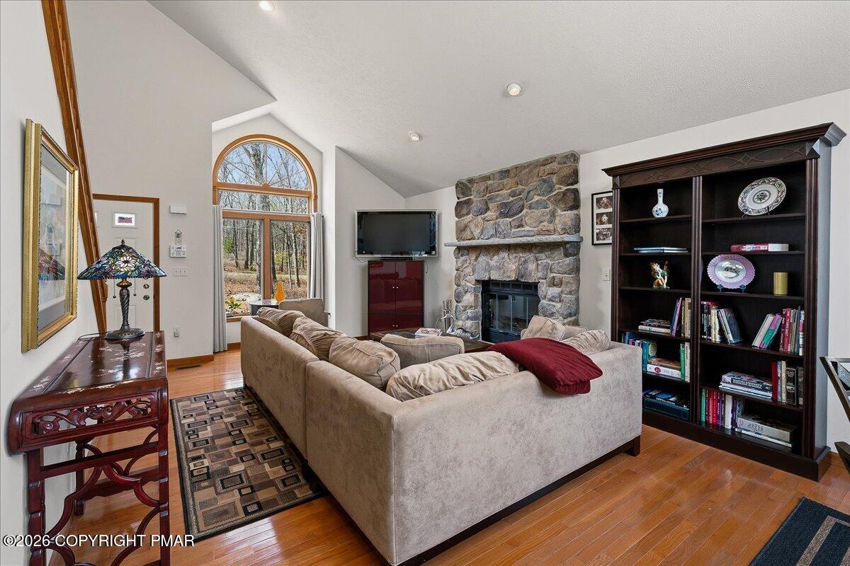 3176 Bluebird Drive Bushkill, PA 18324 - Photo 6 of 37 a living room with furniture fireplace and book shelf