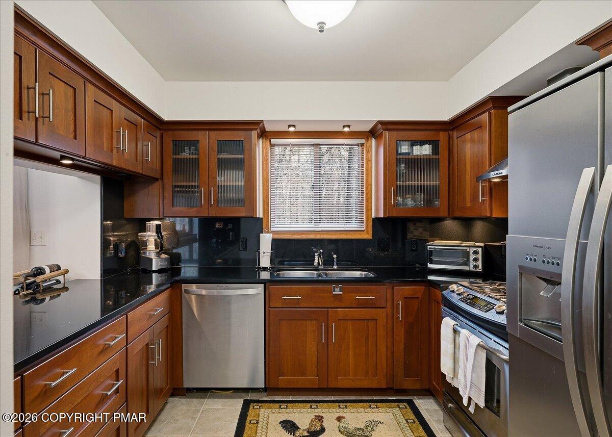 3176 Bluebird Drive Bushkill, PA 18324 - Photo 10 of 37 a kitchen with stainless steel appliances granite countertop a refrigerator and a stove top oven
